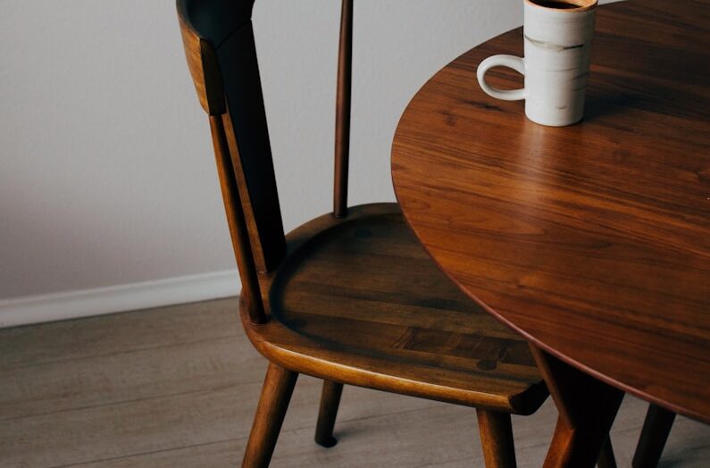 white ceramic mug on brown wooden table