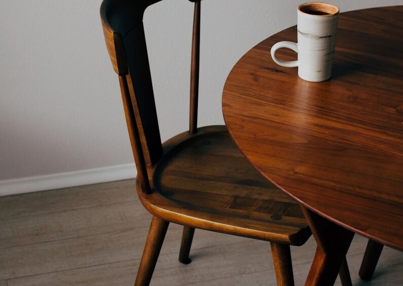 white ceramic mug on brown wooden table